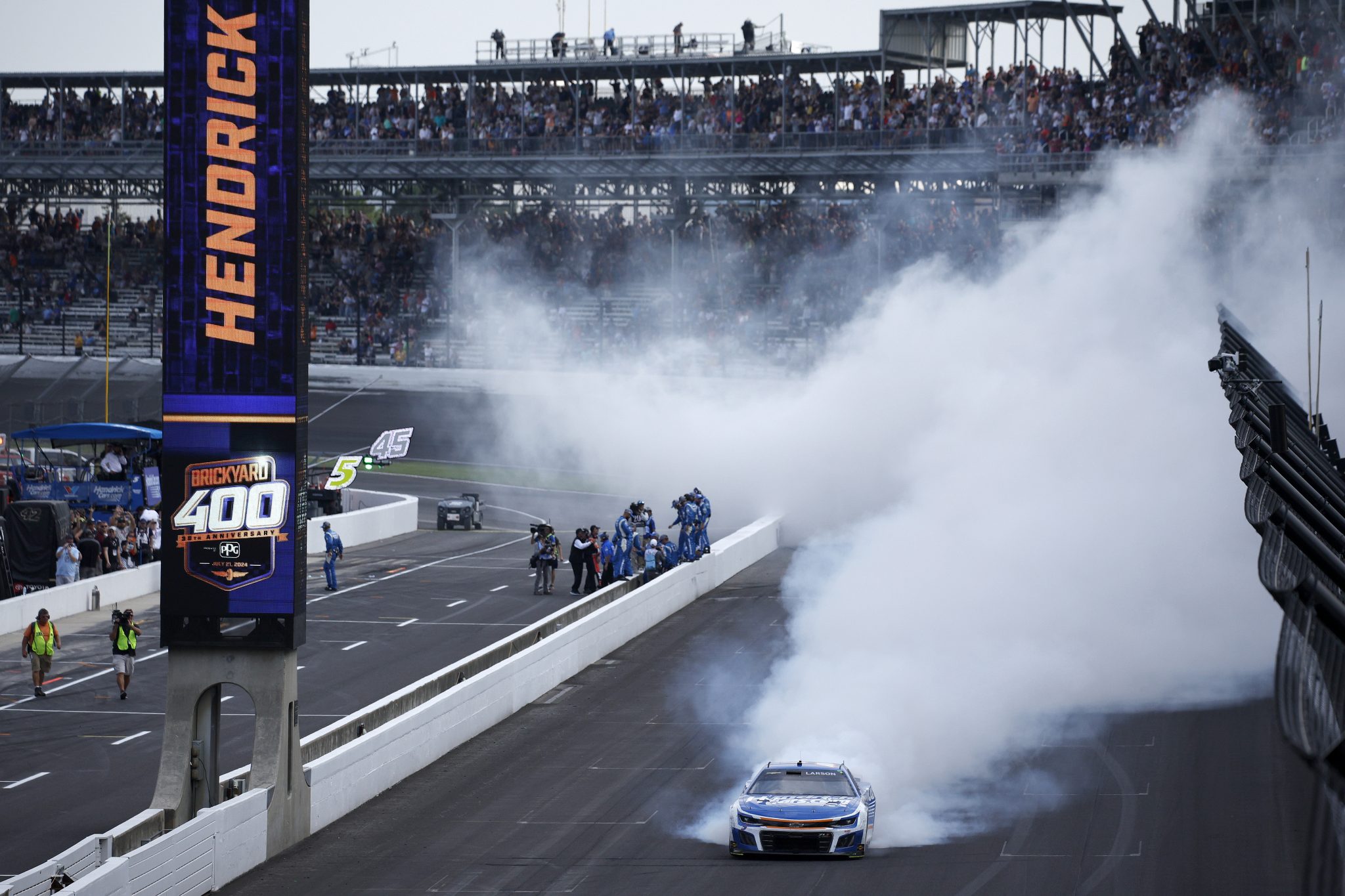 Kyle Larson kisses the bricks at Indianapolis Motor Speedway | Jayski