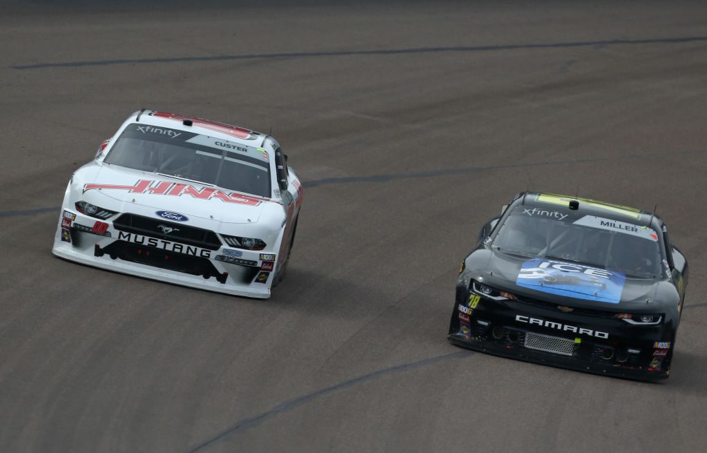 AVONDALE, AZ - MARCH 09: Cole Custer, driver of the #00 Haas Automation Ford, passes Vinnie Miller, driver of the #78 Koolbox Chevrolet, during the NASCAR Xfinity Series iK9 Service Dog 200 at ISM Raceway on March 9, 2019 in Avondale, Arizona. (Photo by Matt Sullivan/Getty Images) | Getty Images