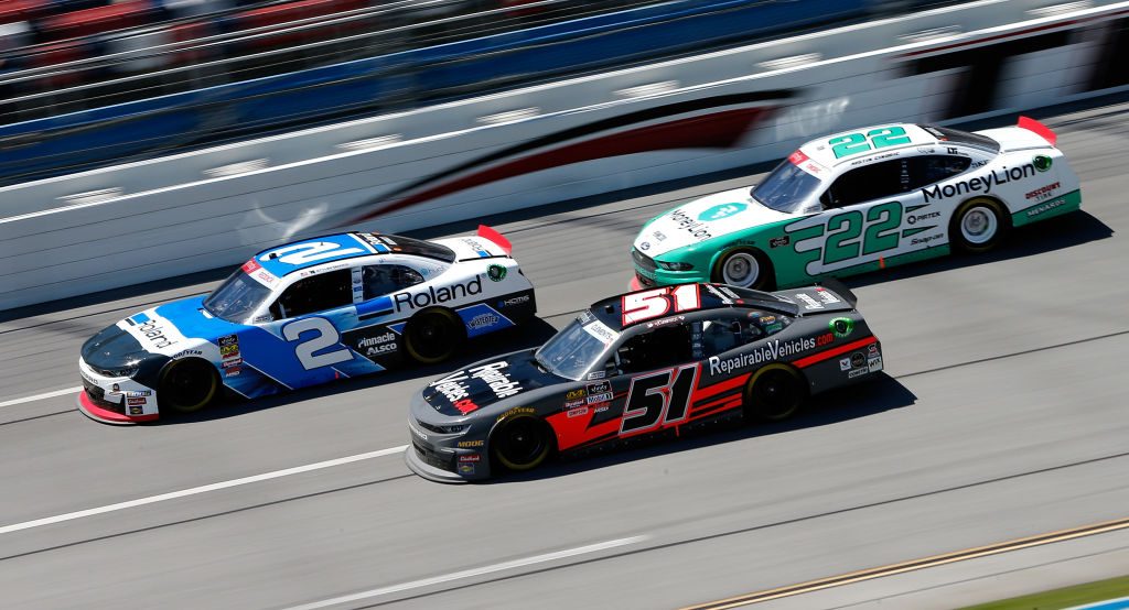 TALLADEGA, AL - APRIL 27: Tyler Reddick, driver of the #2 Roland Chevrolet, leads, Jeremy Clements, driver of the #51 RepairableVehicles.com Chevrolet, and Austin Cindric, driver of the #22 MoneyLion Ford, during the NASCAR Xfinity Series MoneyLion 300 at Talladega Superspeedway on April 27, 2019 in Talladega, Alabama. (Photo by Brian Lawdermilk/Getty Images) | Getty Images