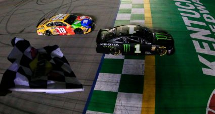 SPARTA, KENTUCKY - JULY 13: Kurt Busch, driver of the #1 Monster Energy Chevrolet, takes the checkered flag ahead of Kyle Busch, driver of the #18 M&M's Toyota Camry Toyota, to win the Monster Energy NASCAR Cup Series Quaker State 400 Presented by Walmart at Kentucky Speedway on July 13, 2019 in Sparta, Kentucky. (Photo by Daniel Shirey/Getty Images)