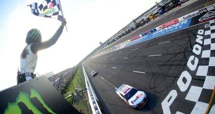 LONG POND, PENNSYLVANIA - JULY 28: Denny Hamlin, driver of the #11 FedEx Ground Toyota, takes the checkered flag to win the Monster Energy NASCAR Cup Series Gander RV 400 at Pocono Raceway on July 28, 2019 in Long Pond, Pennsylvania. (Photo by Jared C. Tilton/Getty Images) | Getty Images