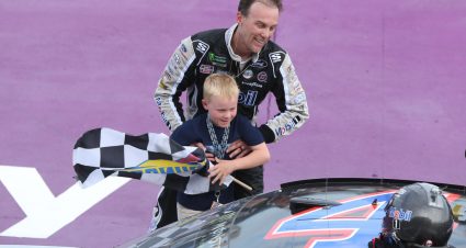 BROOKLYN, MICHIGAN - AUGUST 11: Kevin Harvick, driver of the #4 Mobil 1 Ford, helps his son Keelan into the car with the checkered flag after winning the Monster Energy NASCAR Cup Series Consumers Energy 400 at Michigan International Speedway on August 11, 2019 in Brooklyn, Michigan. (Photo by Matt Sullivan/Getty Images) | Getty Images
