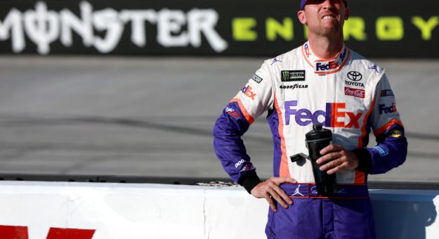 BRISTOL, TENNESSEE - AUGUST 16: Denny Hamlin, driver of the #11 FedEx Freight Toyota, stands on the grid during qualifying for the Monster Energy NASCAR Cup Series Bass Pro Shops NRA Night Race at Bristol Motor Speedway on August 16, 2019 in Bristol, Tennessee. (Photo by Sean Gardner/Getty Images) | Getty Images