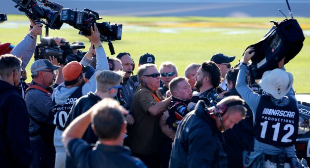KANSAS CITY, KANSAS - OCTOBER 19: Tyler Reddick, driver of the #2 TAME the BEAST Chevrolet, is restrained on pit lane after fighting with Cole Custer, driver of the #00 Production Alliance Group Ford, after the NASCAR Xfinity Series Kansas Lottery 300 at Kansas Speedway on October 19, 2019 in Kansas City, Kansas. (Photo by Jonathan Ferrey/Getty Images) | Getty Images