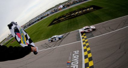 KANSAS CITY, KANSAS - OCTOBER 20: Denny Hamlin, driver of the #11 FedEx Office Toyota, takes the checkered flag ahead of Chase Elliott, driver of the #9 NAPA Auto Parts Chevrolet,  to win the Monster Energy NASCAR Cup Series Hollywood Casino 400 at Kansas Speedway on October 20, 2019 in Kansas City, Kansas. (Photo by Jonathan Ferrey/Getty Images) | Getty Images