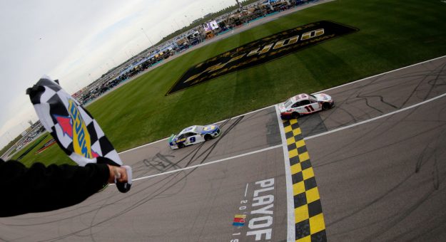 KANSAS CITY, KANSAS - OCTOBER 20: Denny Hamlin, driver of the #11 FedEx Office Toyota, takes the checkered flag ahead of Chase Elliott, driver of the #9 NAPA Auto Parts Chevrolet,  to win the Monster Energy NASCAR Cup Series Hollywood Casino 400 at Kansas Speedway on October 20, 2019 in Kansas City, Kansas. (Photo by Jonathan Ferrey/Getty Images) | Getty Images