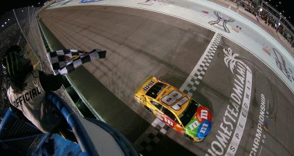 HOMESTEAD, FLORIDA - NOVEMBER 17: Kyle Busch, driver of the #18 M&M's Toyota, takes the checkered flag to win the Monster Energy NASCAR Cup Series Championship and the Monster Energy NASCAR Cup Series Ford EcoBoost 400 at Homestead Speedway on November 17, 2019 in Homestead, Florida. (Photo by Sean Gardner/Getty Images) | Getty Images