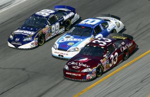 DAYTONA BEACH, FL - FEBRUARY 18: Tony Stewart driver of the #33 Old Spice Chevrolet and Dale Earnhardt Jr. driver of the #8 Kraft Chevrolet and Michael Waltrip driver of the #99 Aaron's Sales & Lease Dodge battle for the lead late during the NASCAR Nextel Cup Busch Series Hershey's Kissables 300 on February 18, 2006 at Daytona International Speedway in Daytona Beach, Florida. (Photo by Gavin Lawrence/Getty Images) | Getty Images