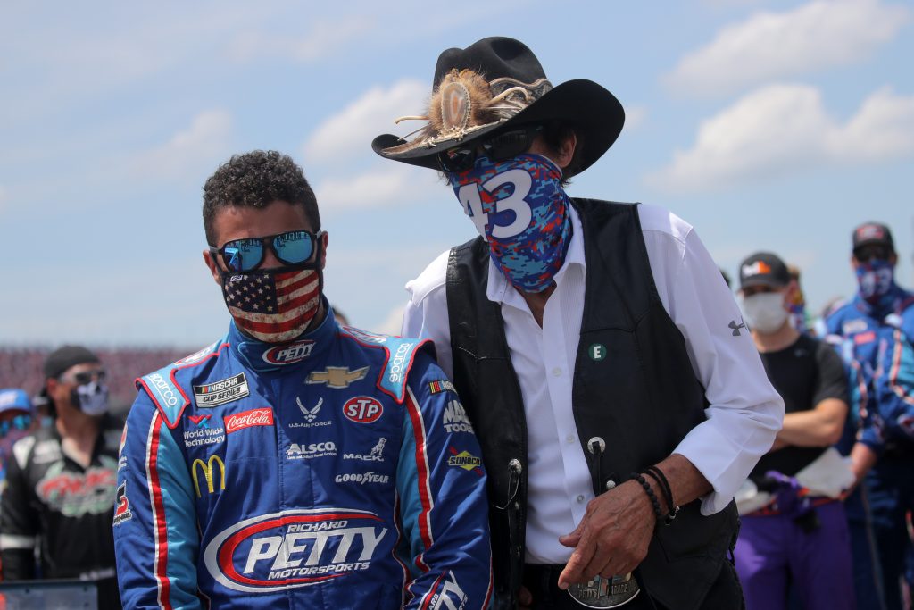 TALLADEGA, ALABAMA - JUNE 22: Team owner and NASCAR Hall of Famer Richard Petty stands with Bubba Wallace, driver of the #43 Victory Junction Chevrolet, during pre-race ceremonies prior to the NASCAR Cup Series GEICO 500 at Talladega Superspeedway on June 22, 2020 in Talladega, Alabama. A noose was found in the garage stall of NASCAR driver Bubba Wallace at Talladega Superspeedway a week after the organization banned the Confederate flag at its facilities. (Photo by Chris Graythen/Getty Images) | Getty Images
