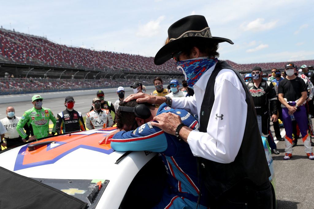 TALLADEGA, ALABAMA - JUNE 22: Bubba Wallace, driver of the #43 Victory Junction Chevrolet, is embraced by team owner, and NASCAR Hall of Famer Richard Petty prior to the NASCAR Cup Series GEICO 500 at Talladega Superspeedway on June 22, 2020 in Talladega, Alabama. A noose was found in the garage stall of NASCAR driver Bubba Wallace at Talladega Superspeedway a week after the organization banned the Confederate flag at its facilities. (Photo by Chris Graythen/Getty Images) | Getty Images