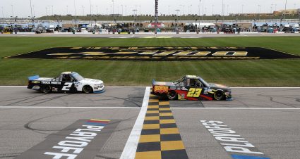 KANSAS CITY, KANSAS - OCTOBER 17: Brett Moffitt, driver of the #23 Concrete Supply Chevrolet, crosses the finish line over Sheldon Creed, driver of the #2 Chevy Truck Month Chevrolet, to win the NASCAR Gander RV & Outdoors Truck Series Clean Harbors 200at Kansas Speedway on October 17, 2020 in Kansas City, Kansas. (Photo by Jamie Squire/Getty Images) | Getty Images