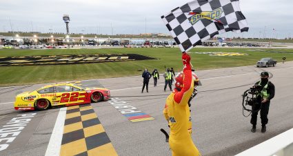 KANSAS CITY, KANSAS - OCTOBER 18: Joey Logano, driver of the #22 Shell Pennzoil Ford, celebrates with the checkered flag after winning the NASCAR Cup Series  Hollywood Casino 400 at Kansas Speedway on October 18, 2020 in Kansas City, Kansas. (Photo by Jamie Squire/Getty Images) | Getty Images