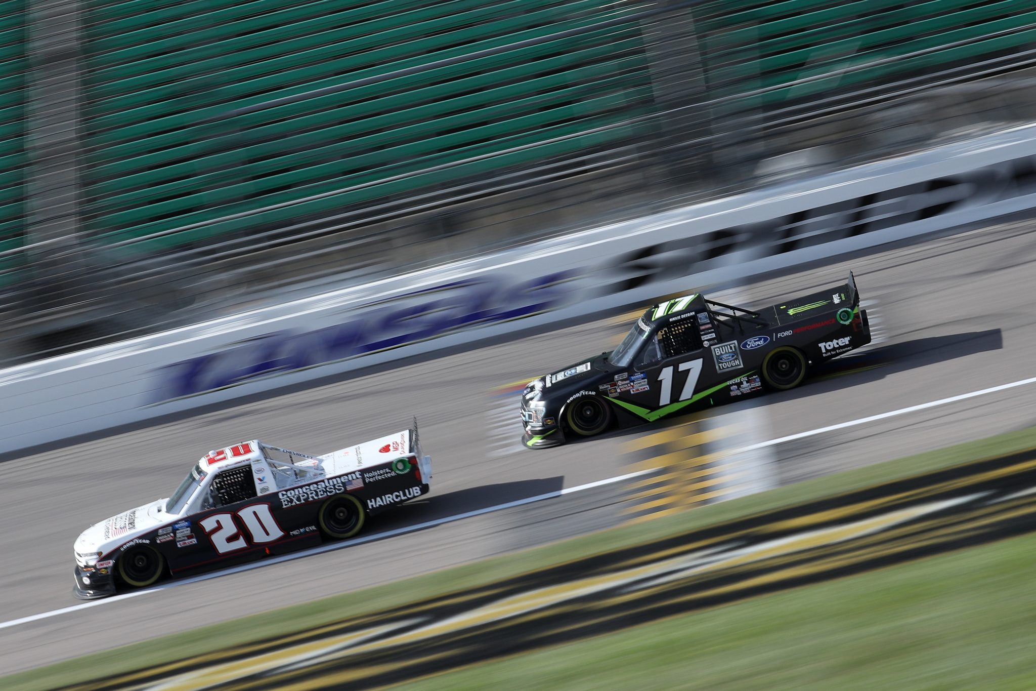 KANSAS CITY, KANSAS - OCTOBER 17: Spencer Boyd, driver of the #20 Concealment Express Chevrolet, and Hailie Deegan, driver of the #17 FORD Ford, race during the NASCAR Gander RV & Outdoors Truck Series Clean Harbors 200at Kansas Speedway on October 17, 2020 in Kansas City, Kansas. (Photo by Chris Graythen/Getty Images) | Getty Images