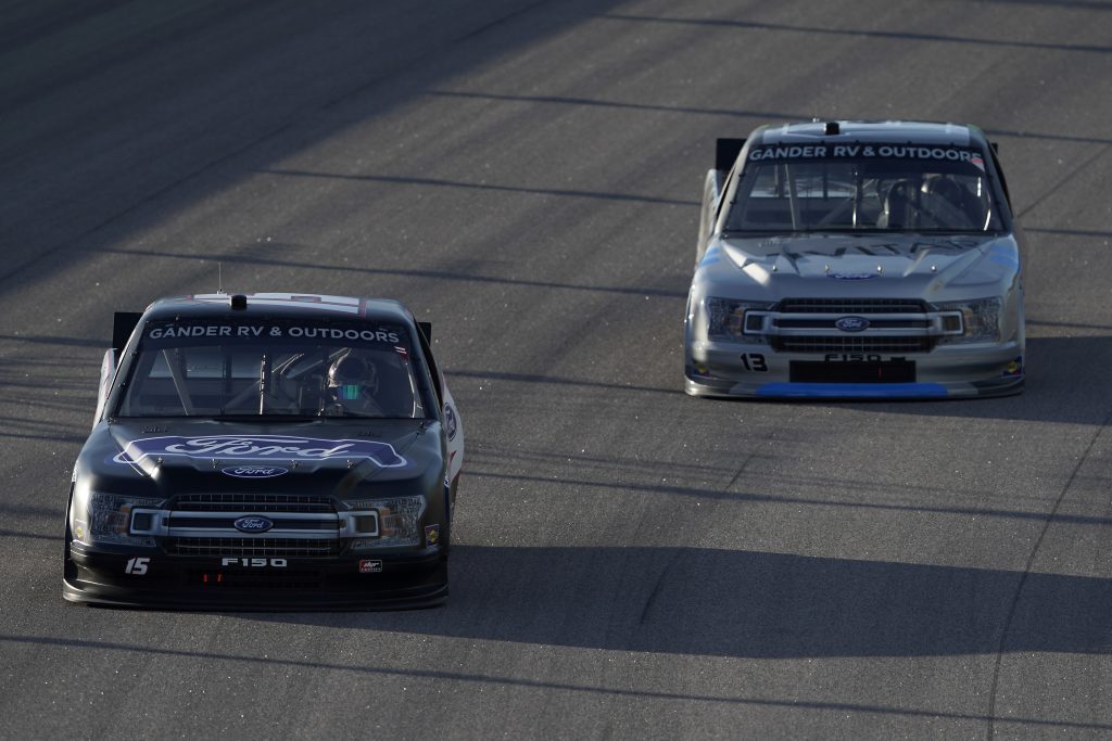 KANSAS CITY, KANSAS - JULY 24: Tanner Gray, driver of the #15 Ford/Ford Performance Ford, races Johnny Sauter, driver of the #13 Vivitar Ford, during the NASCAR Gander RV & Outdoors Truck Series Kansas 200 at Kansas Speedway on July 24, 2020 in Kansas City, Kansas. (Photo by Kyle Rivas/Getty Images) | Getty Images