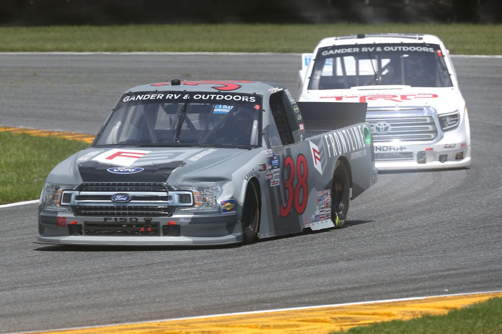 DAYTONA BEACH, FLORIDA - AUGUST 16: Todd Gilliland, driver of the #38 Frontline Enterprises Inc Ford, races Austin Hill, driver of the #16 Toyota Racing Development Toyota, during the NASCAR Gander RV & Outdoors Truck Series Sunoco 159 at Daytona International Speedway on August 16, 2020 in Daytona Beach, Florida. (Photo by Chris Graythen/Getty Images) | Getty Images