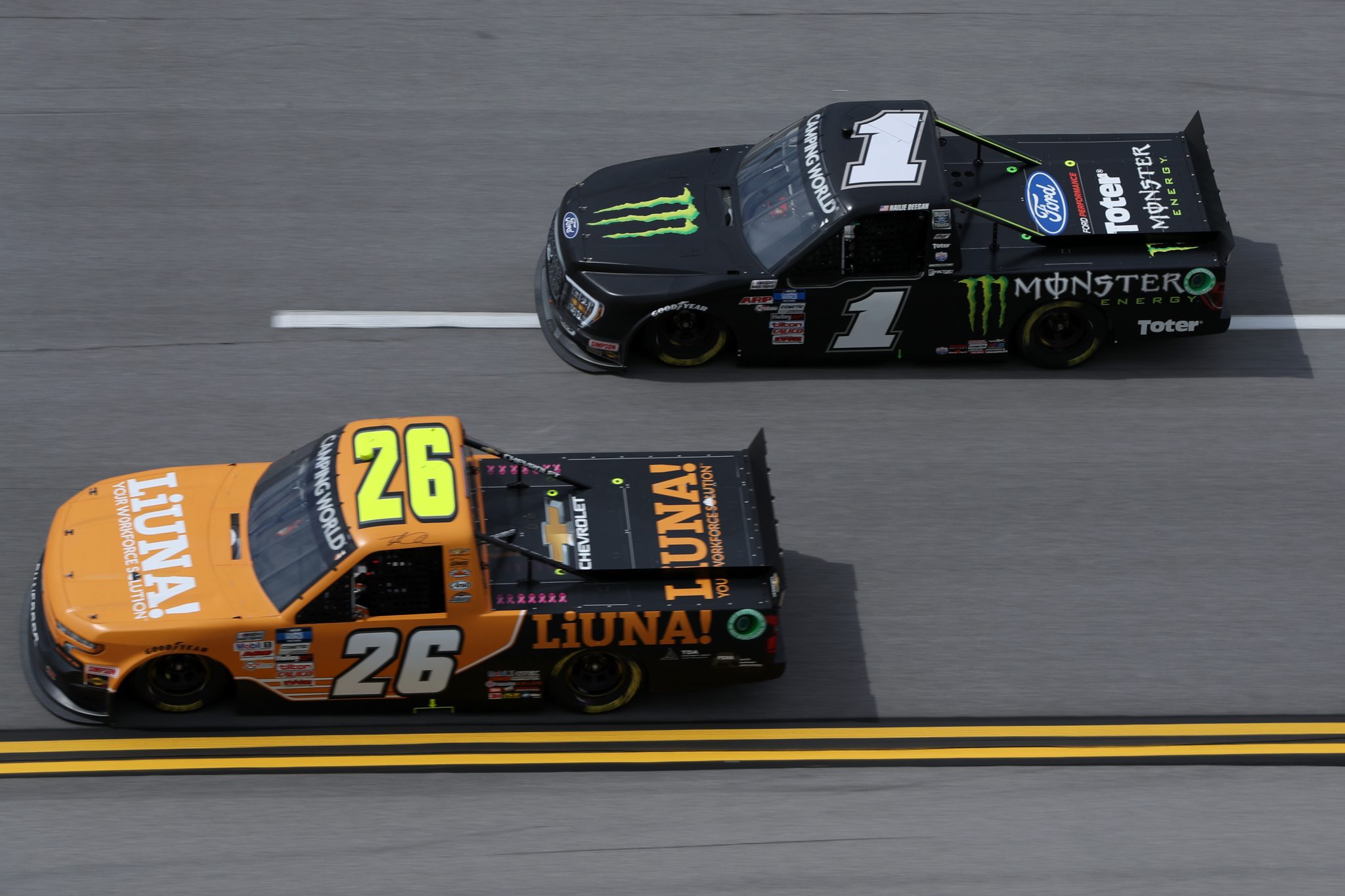 TALLADEGA, ALABAMA - OCTOBER 02: Hailie Deegan, driver of the #1 Monster Ford, and Tyler Ankrum, driver of the #26 LiUNA! Chevrolet, race during the NASCAR Camping World Truck Series Chevrolet Silverado 250 at Talladega Superspeedway on October 02, 2021 in Talladega, Alabama. (Photo by Sean Gardner/Getty Images) | Getty Images