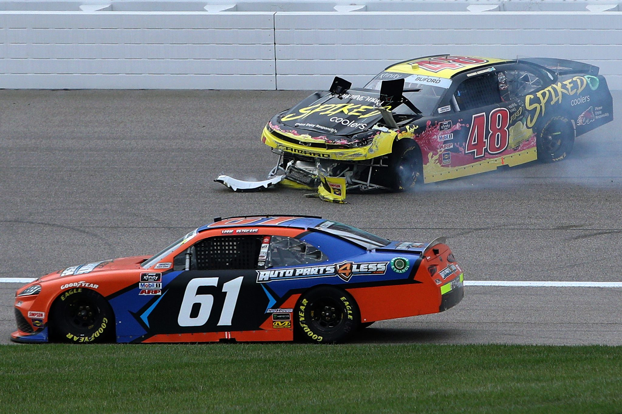 KANSAS CITY, KANSAS - OCTOBER 23: Jade Buford, driver of the #48 Big Machine Spiked Coolers Chevrolet, spins into the wall as Chad Finchum, driver of the #61 AutoParts4Less.com Toyota, drives by during the NASCAR Xfinity Series Kansas Lottery 300 at Kansas Speedway on October 23, 2021 in Kansas City, Kansas. (Photo by Sean Gardner/Getty Images) | Getty Images