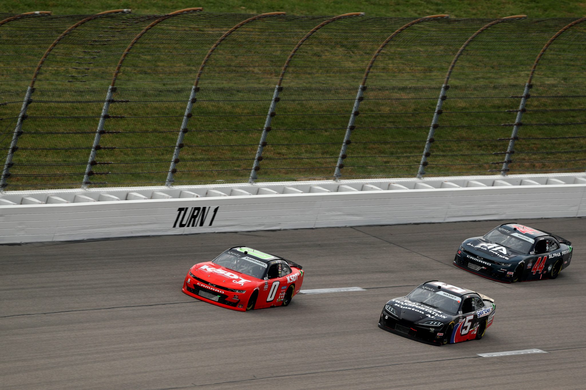 KANSAS CITY, KANSAS - OCTOBER 23: Jeffrey Earnhardt, driver of the #0 TeamJDMotorsports.com Chevrolet, Mason Massey, driver of the #5 Gerber Collision & Glass Toyota, and Tommy Joe Martins, driver of the #44 Alpha Prime Chevrolet, race during the NASCAR Xfinity Series Kansas Lottery 300 at Kansas Speedway on October 23, 2021 in Kansas City, Kansas. (Photo by Meg Oliphant/Getty Images) | Getty Images