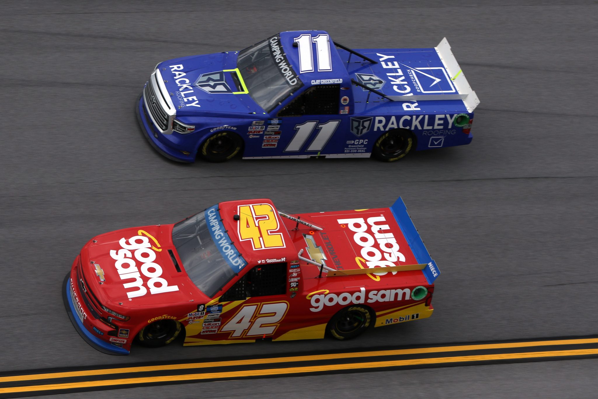 TALLADEGA, ALABAMA - OCTOBER 02: Carson Hocevar, driver of the #42 Good Sam Chevrolet, and Clay Greenfield, driver of the #11 Toyota, race during the NASCAR Camping World Truck Series Chevrolet Silverado 250 at Talladega Superspeedway on October 02, 2021 in Talladega, Alabama. (Photo by Sean Gardner/Getty Images) | Getty Images