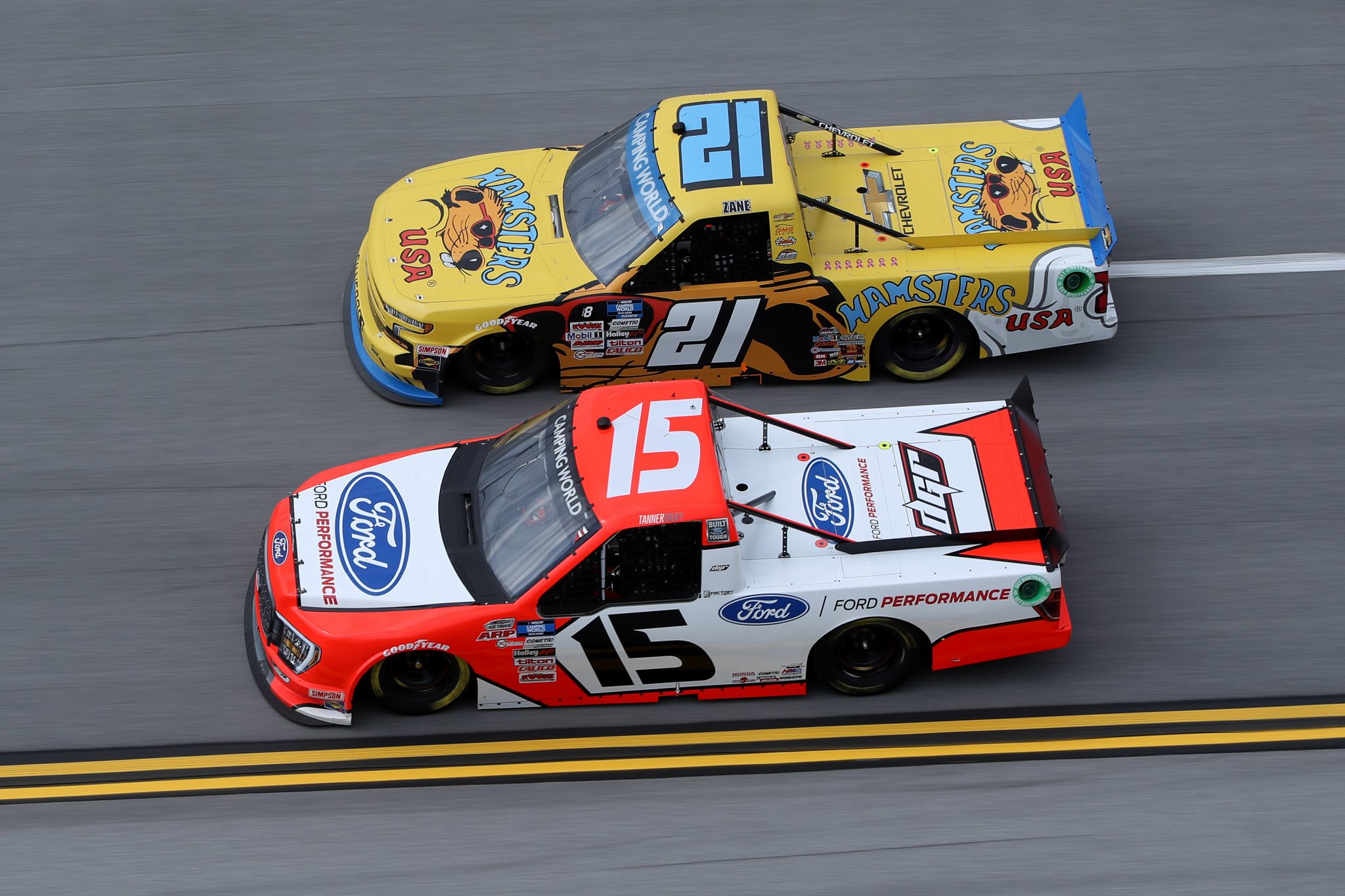 TALLADEGA, ALABAMA - OCTOBER 02: Tanner Gray, driver of the #15 Ford Performance Ford, and Zane Smith, driver of the #21 Hamsters USA Chevrolet, race during the NASCAR Camping World Truck Series Chevrolet Silverado 250 at Talladega Superspeedway on October 02, 2021 in Talladega, Alabama. (Photo by Sean Gardner/Getty Images) | Getty Images
