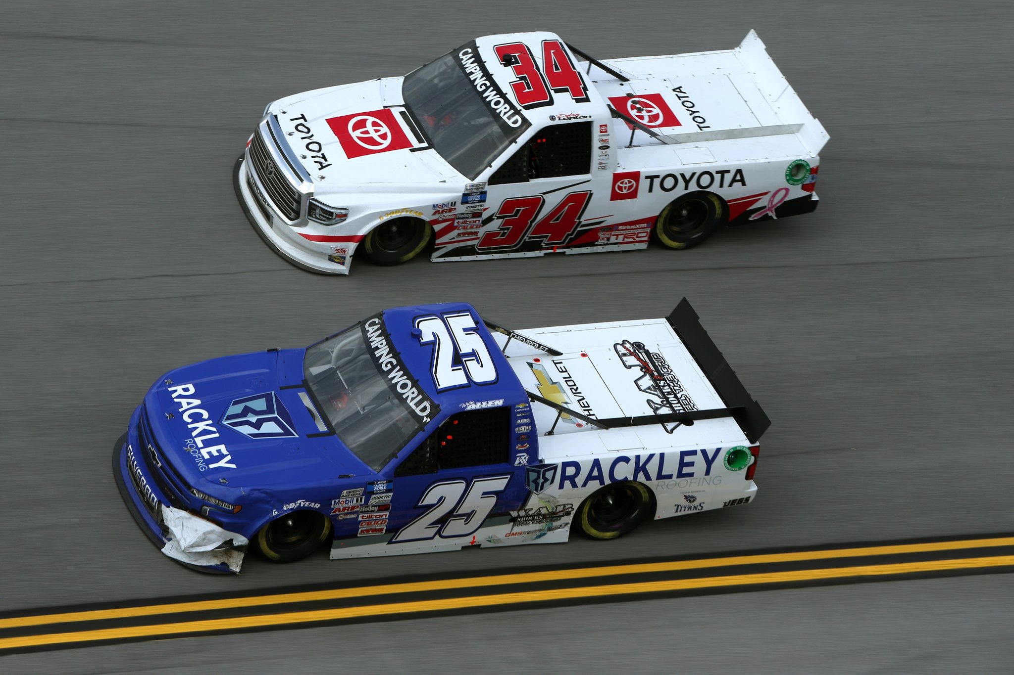 TALLADEGA, ALABAMA - OCTOBER 02: Willie Allen, driver of the #25 Rackley Roofing Chevrolet, and Dylan Lupton, driver of the #34 Toyota, race during the NASCAR Camping World Truck Series Chevrolet Silverado 250 at Talladega Superspeedway on October 02, 2021 in Talladega, Alabama. (Photo by Sean Gardner/Getty Images) | Getty Images