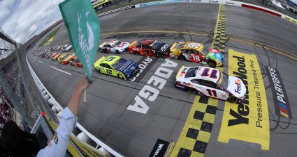 TALLADEGA, ALABAMA - OCTOBER 04: Denny Hamlin, driver of the #11 FedEx Express Toyota, leads Kyle Busch, driver of the #18 M&M's Toyota, and Chase Elliott, driver of the #9 Adrenaline Shoc Chevrolet, to the green flag to start the NASCAR Cup Series YellaWood 500 at Talladega Superspeedway on October 04, 2021 in Talladega, Alabama. (Photo by Brian Lawdermilk/Getty Images) | Getty Images