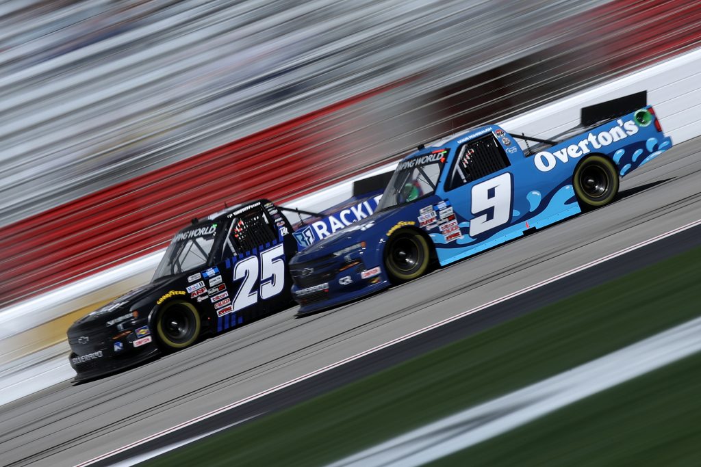 HAMPTON, GEORGIA - MARCH 20: Timothy Peters, driver of the #25 Rackley Roofing Chevrolet, and Codie Rohrbaugh, driver of the #9 Overton's Chevrolet, race during the NASCAR Camping World Truck Series Fr8Auctions 200 at Atlanta Motor Speedway on March 20, 2021 in Hampton, Georgia. (Photo by Sean Gardner/Getty Images) | Getty Images