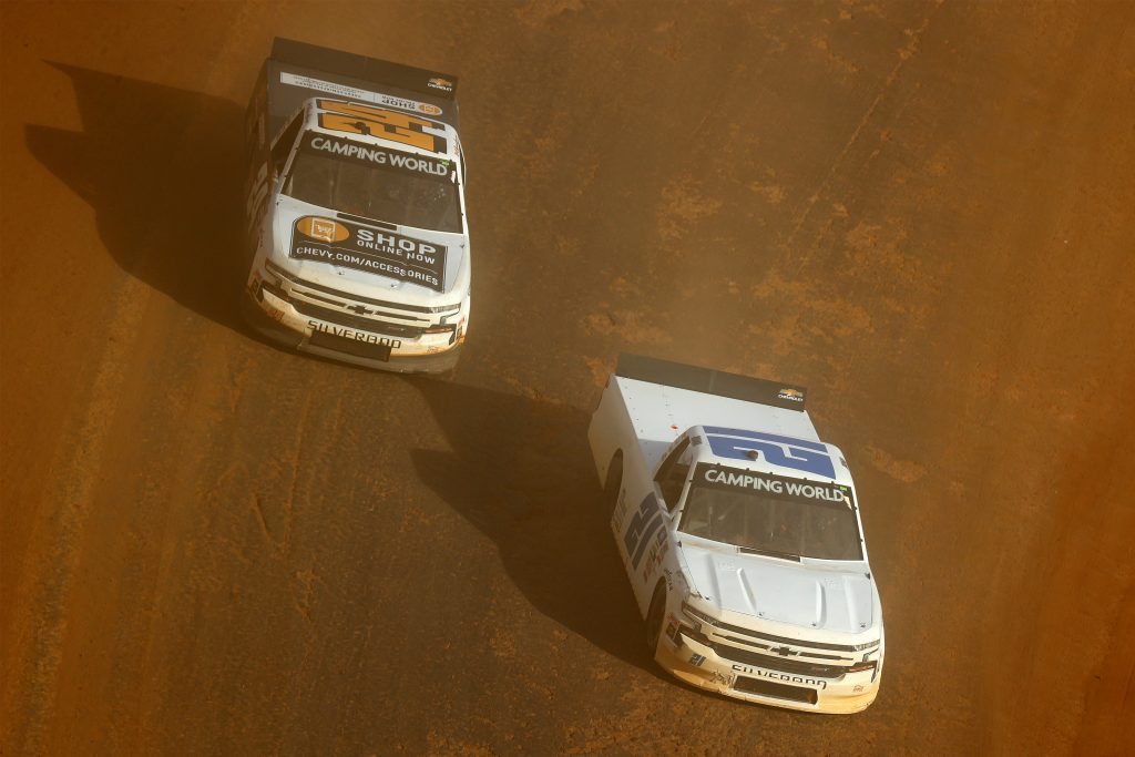 BRISTOL, TENNESSEE - MARCH 26: Zane Smith, driver of the #21 GMS Racing Chevrolet, and Raphael Lessard, driver of the #24 Chevy Accessories Chevrolet, race during practice for the NASCAR Camping World Truck Series Pinty's Truck Race on Dirt at Bristol Motor Speedway on March 26, 2021 in Bristol, Tennessee. (Photo by Jared C. Tilton/Getty Images) | Getty Images