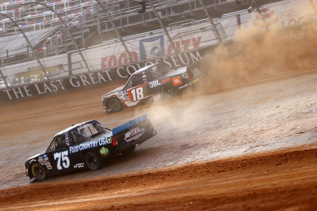 BRISTOL, TENNESSEE - MARCH 26: Parker Kligerman, driver of the #75 Food Country USA Chevrolet, and Chandler Smith, driver of the #18 JBL Toyota, race during practice for the NASCAR Camping World Truck Series Pinty's Truck Race on Dirt at Bristol Motor Speedway on March 26, 2021 in Bristol, Tennessee. (Photo by Chris Graythen/Getty Images) | Getty Images