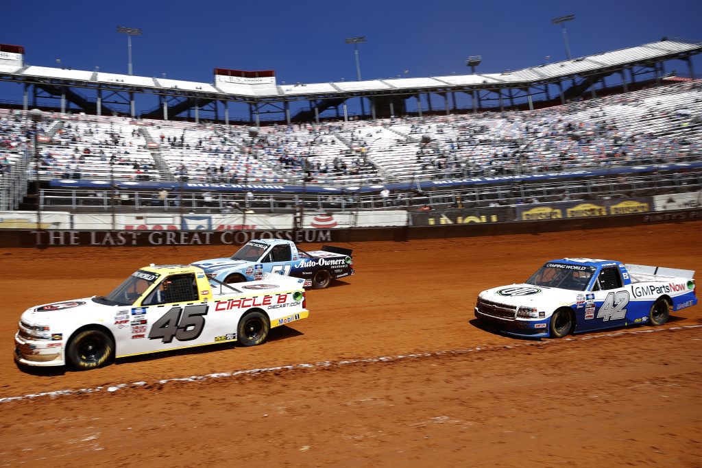 BRISTOL, TENNESSEE - MARCH 29: Brett Moffitt, driver of the #45 Circle B Diecast Chevrolet, and Carson Hocevar, driver of the #42 Scott's/GMPartsNow Chevrolet, race during the NASCAR Camping World Truck Series Pinty's Truck Race on Dirt at Bristol Motor Speedway on March 29, 2021 in Bristol, Tennessee. (Photo by Chris Graythen/Getty Images) | Getty Images