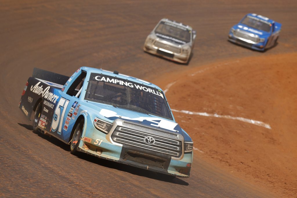 BRISTOL, TENNESSEE - MARCH 29: Martin Truex Jr., driver of the #51 Auto-Owners Insurance Toyota, leads the field during the NASCAR Camping World Truck Series Pinty's Truck Race on Dirt at Bristol Motor Speedway on March 29, 2021 in Bristol, Tennessee. (Photo by Jared C. Tilton/Getty Images) | Getty Images