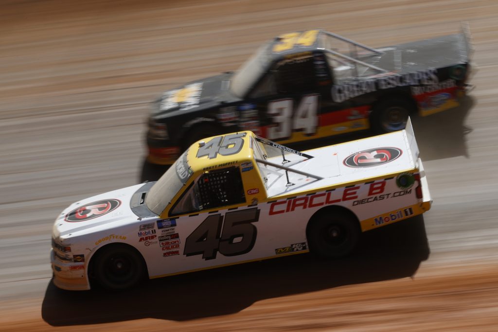 BRISTOL, TENNESSEE - MARCH 29: Brett Moffitt, driver of the #45 Circle B Diecast Chevrolet, and Jake Griffin, driver of the #34 Great Escapes RV Center Toyota, race during the NASCAR Camping World Truck Series Pinty's Truck Race on Dirt at Bristol Motor Speedway on March 29, 2021 in Bristol, Tennessee. (Photo by Chris Graythen/Getty Images) | Getty Images