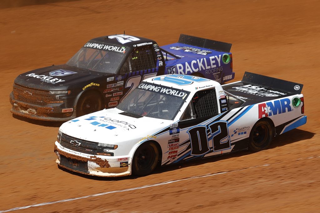 BRISTOL, TENNESSEE - MARCH 29: Daniel Suarez, driver of the #02 Freeway Insurance Chevrolet, and Timothy Peters, driver of the #25 Rackley Roofing Chevrolet, race during the NASCAR Camping World Truck Series Pinty's Truck Race on Dirt at Bristol Motor Speedway on March 29, 2021 in Bristol, Tennessee. (Photo by Chris Graythen/Getty Images) | Getty Images