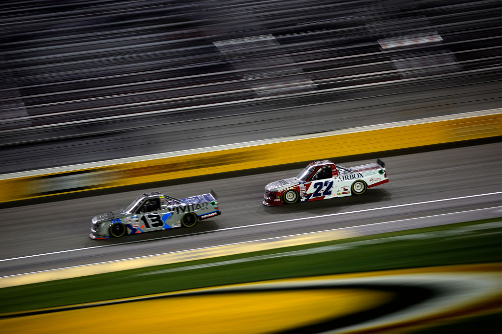 LAS VEGAS, NEVADA - MARCH 05: Austin Wayne Self, driver of the #22 AIRBOX Air Purifiers Chevrolet, and Johnny Sauter, driver of the #13 Vivitar/RealTree Toyota, race during the NASCAR Camping World Truck Series Bucked Up 200 at The Bullring at Las Vegas Motor Speedway on March 05, 2021 in Las Vegas, Nevada. (Photo by Chris Graythen/Getty Images) | Getty Images