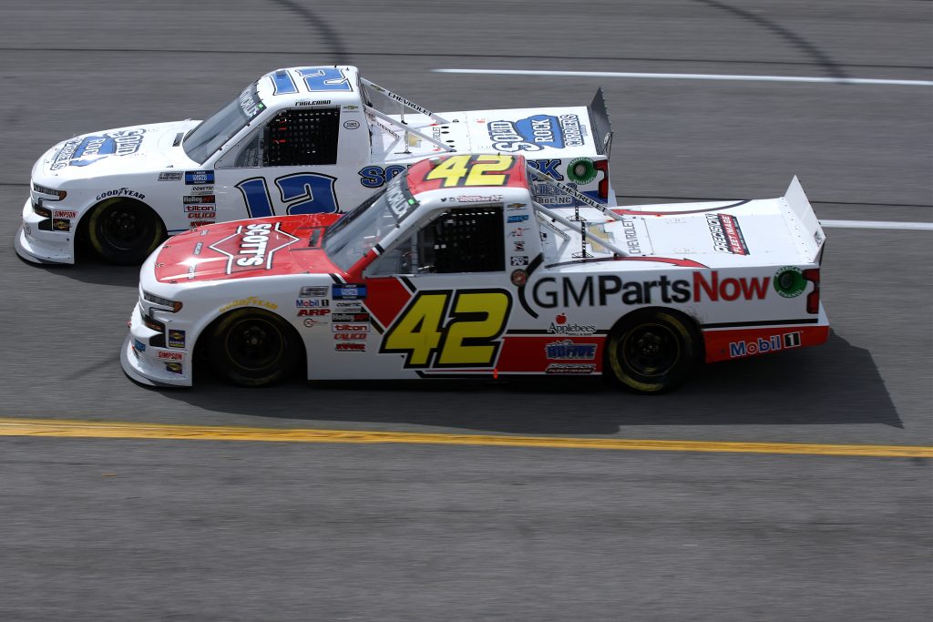 RICHMOND, VIRGINIA - APRIL 17: Tate Fogleman, driver of the #12 Solid Rock Carriers Chevrolet, and Carson Hocevar, driver of the #42 Scott's/GMPartsNow Chevrolet, race during the NASCAR Camping World Truck Series ToyotaCare 250 at Richmond Raceway on April 17, 2021 in Richmond, Virginia. (Photo by Sean Gardner/Getty Images) | Getty Images