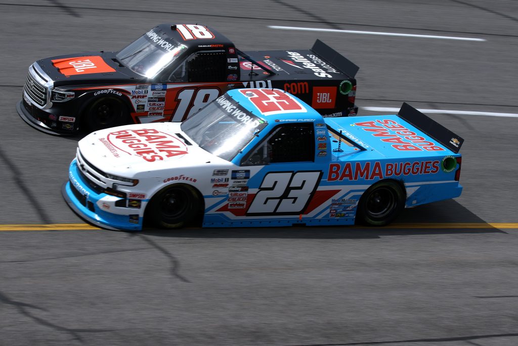 RICHMOND, VIRGINIA - APRIL 17: Chase Purdy, driver of the #23 BamaBuggies.com Chevrolet, and Chandler Smith, driver of the #18 JBL Toyota, race during the NASCAR Camping World Truck Series ToyotaCare 250 at Richmond Raceway on April 17, 2021 in Richmond, Virginia. (Photo by Sean Gardner/Getty Images) | Getty Images