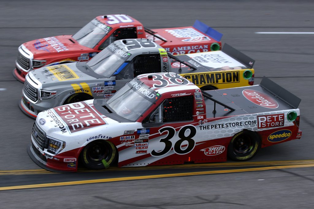 RICHMOND, VIRGINIA - APRIL 17: Todd Gilliland, driver of the #38 Ford, Grant Enfinger, driver of the #98 Champion/Camping World/Curb Records Toyota, and Danny Bohn, driver of the #30 North American Motor Car Toyota, race during the NASCAR Camping World Truck Series ToyotaCare 250 at Richmond Raceway on April 17, 2021 in Richmond, Virginia. (Photo by Sean Gardner/Getty Images) | Getty Images