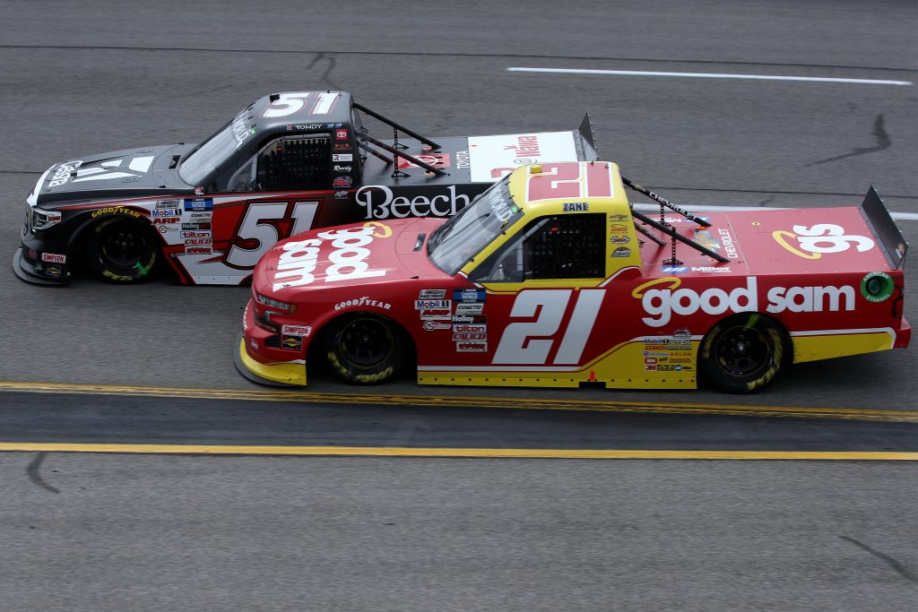 RICHMOND, VIRGINIA - APRIL 17: Zane Smith, driver of the #21 Chevrolet, and Kyle Busch, driver of the #51 Cessna Toyota, race during the NASCAR Camping World Truck Series ToyotaCare 250 at Richmond Raceway on April 17, 2021 in Richmond, Virginia. (Photo by Sean Gardner/Getty Images) | Getty Images