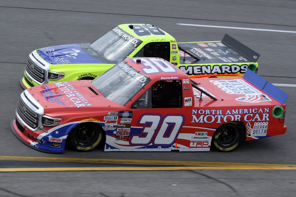 RICHMOND, VIRGINIA - APRIL 17: Danny Bohn, driver of the #30 North American Motor Car Toyota, and Matt Crafton, driver of the #88 Great Lakes Flooring/Menards Toyota, race during the NASCAR Camping World Truck Series ToyotaCare 250 at Richmond Raceway on April 17, 2021 in Richmond, Virginia. (Photo by Sean Gardner/Getty Images) | Getty Images