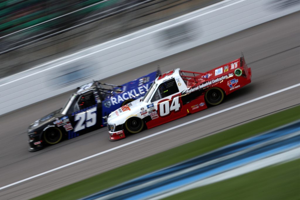 KANSAS CITY, KANSAS - MAY 01: Chase Briscoe, driver of the #04 TrickShot Ford, and Timothy Peters, driver of the #25 Rackley Roofing Chevrolet, race during the NASCAR Camping World Truck Series Wise Power 200 at Kansas Speedway on May 01, 2021 in Kansas City, Kansas. (Photo by Sean Gardner/Getty Images) | Getty Images