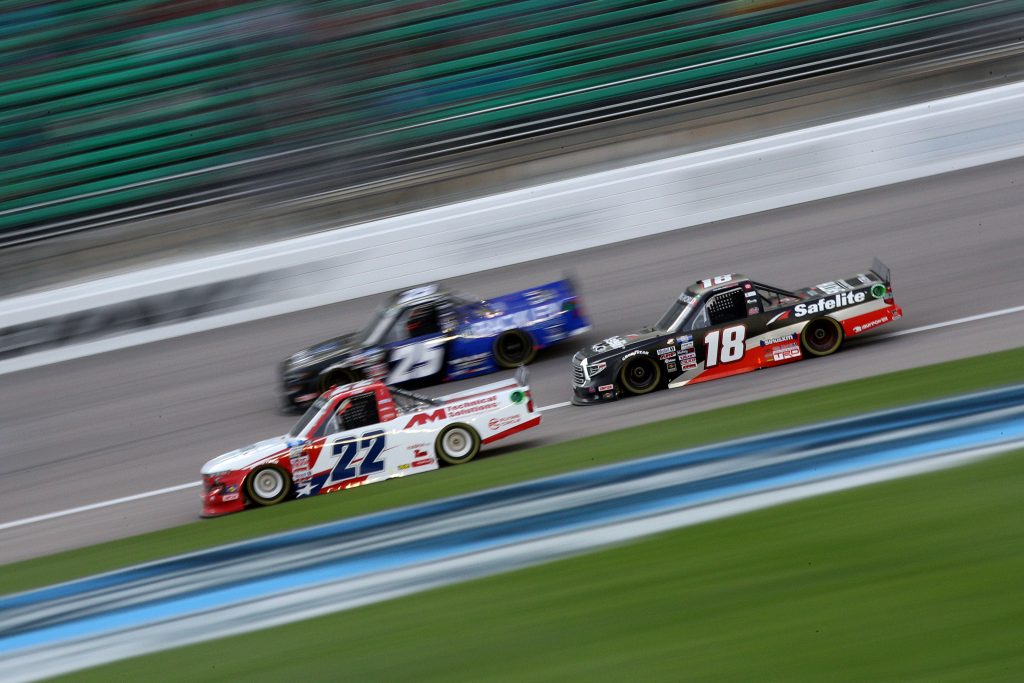 KANSAS CITY, KANSAS - MAY 01: Austin Wayne Self, driver of the #22 AIRBOX/AM Technical Solutions Chevrolet, Chandler Smith, driver of the #18 Safelite AutoGlass Toyota, and Timothy Peters, driver of the #25 Rackley Roofing Chevrolet, race during the NASCAR Camping World Truck Series Wise Power 200 at Kansas Speedway on May 01, 2021 in Kansas City, Kansas. (Photo by Sean Gardner/Getty Images) | Getty Images