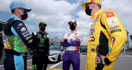KANSAS CITY, KANSAS - MAY 02: Kevin Harvick, driver of the #4 Busch Light For The Farmers Ford, Kurt Busch, driver of the #1 Monster Energy Chevrolet, Denny Hamlin, driver of the #11 FedEx Freight Toyota, Kyle Busch, driver of the #18 M&M's Mix Toyota, talk on the grid prior to the NASCAR Cup Series Buschy McBusch Race 400 at Kansas Speedway on May 02, 2021 in Kansas City, Kansas. (Photo by Sean Gardner/Getty Images) | Getty Images