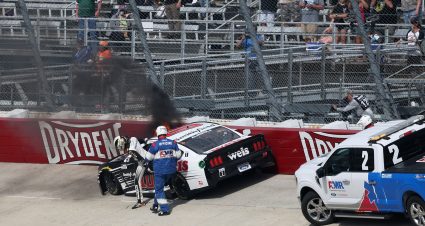 DOVER, DELAWARE - MAY 16: Aric Almirola, driver of the #10 Smithfield/Weis Markets Ford, exits his car as it catches fire after a wreck during the NASCAR Cup Series Drydene 400 at Dover International Speedway on May 16, 2021 in Dover, Delaware. (Photo by James Gilbert/Getty Images) | Getty Images