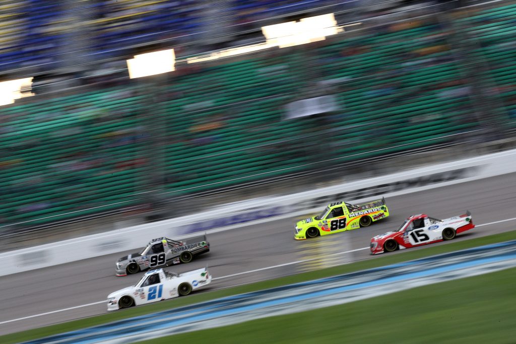 KANSAS CITY, KANSAS - MAY 01: Ben Rhodes, driver of the #99 Bombardier LearJet 75 Toyota, Matt Crafton, driver of the #88 Ideal Door/Menards Toyota, Zane Smith, driver of the #21 Chevrolet, and Tanner Gray, driver of the #15 Ford Performance Ford, race during the NASCAR Camping World Truck Series Wise Power 200 at Kansas Speedway on May 01, 2021 in Kansas City, Kansas. (Photo by Sean Gardner/Getty Images) | Getty Images