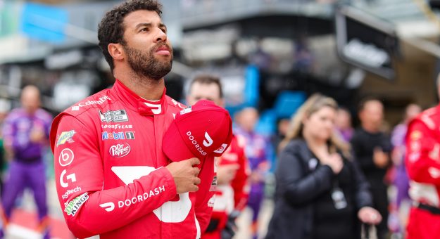 AUSTIN, TEXAS - MAY 23: Bubba Wallace, driver of the #23 DoorDash Toyota, stands during the national anthem prior to the NASCAR Cup Series EchoPark Texas Grand Prix at Circuit of The Americas on May 23, 2021 in Austin, Texas. (Photo by Carmen Mandato/23XI Racing via Getty Images)