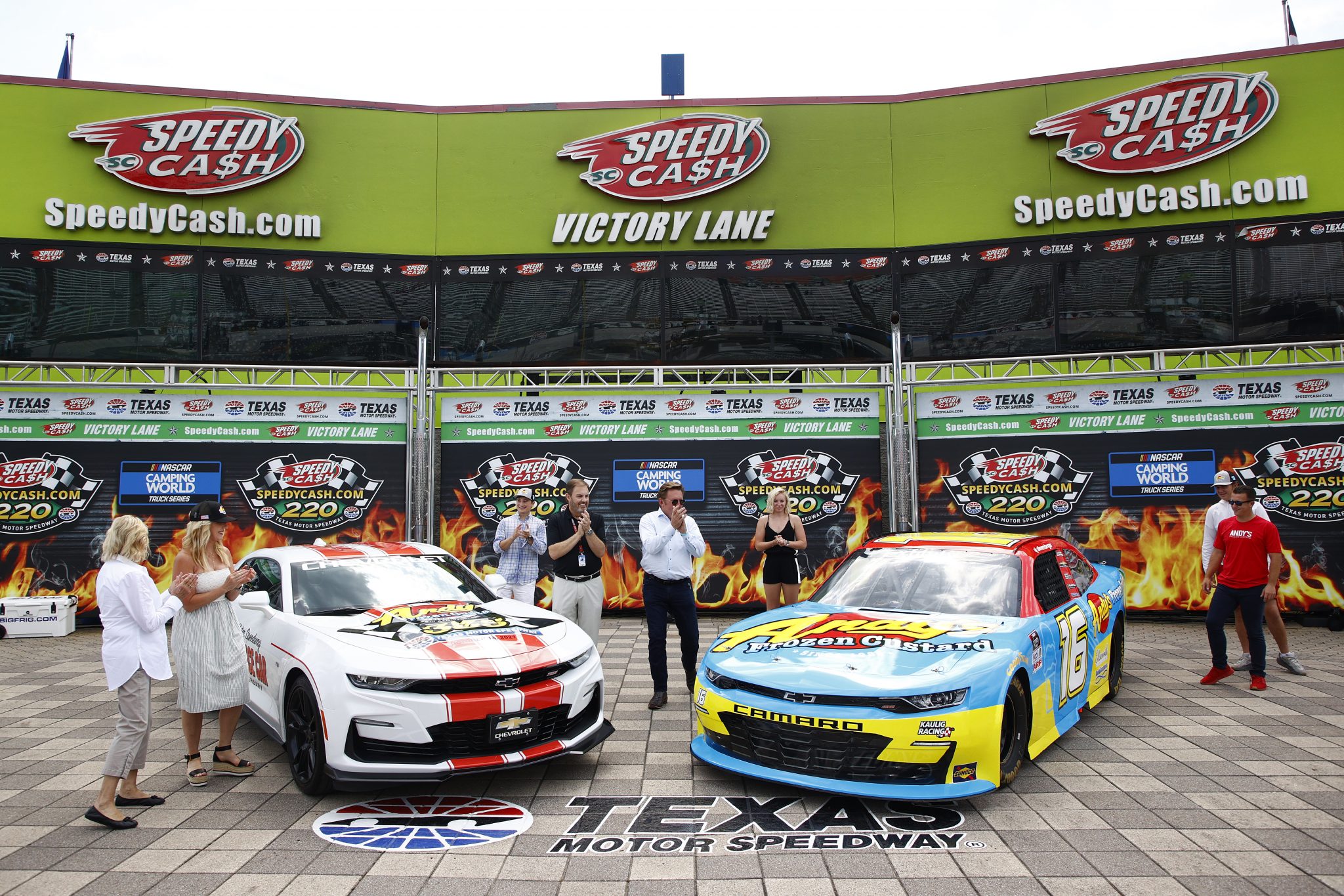 FORT WORTH, TEXAS - JUNE 12: (L-R) Andy Kuntz, CEO & owner of Andy’s Frozen Custard Texas Motor Speedway President Eddie Gossage and Xfinity driver A. J. Allmendinger pose for photos after unveiling the paint scheme for the the #16 Andy’s Frozen Custard Chevrolet prior to the NASCAR Xfinity Series Alsco Uniforms 250 at Texas Motor Speedway on June 12, 2021 in Fort Worth, Texas. (Photo by Jared C. Tilton/Getty Images) | Getty Images