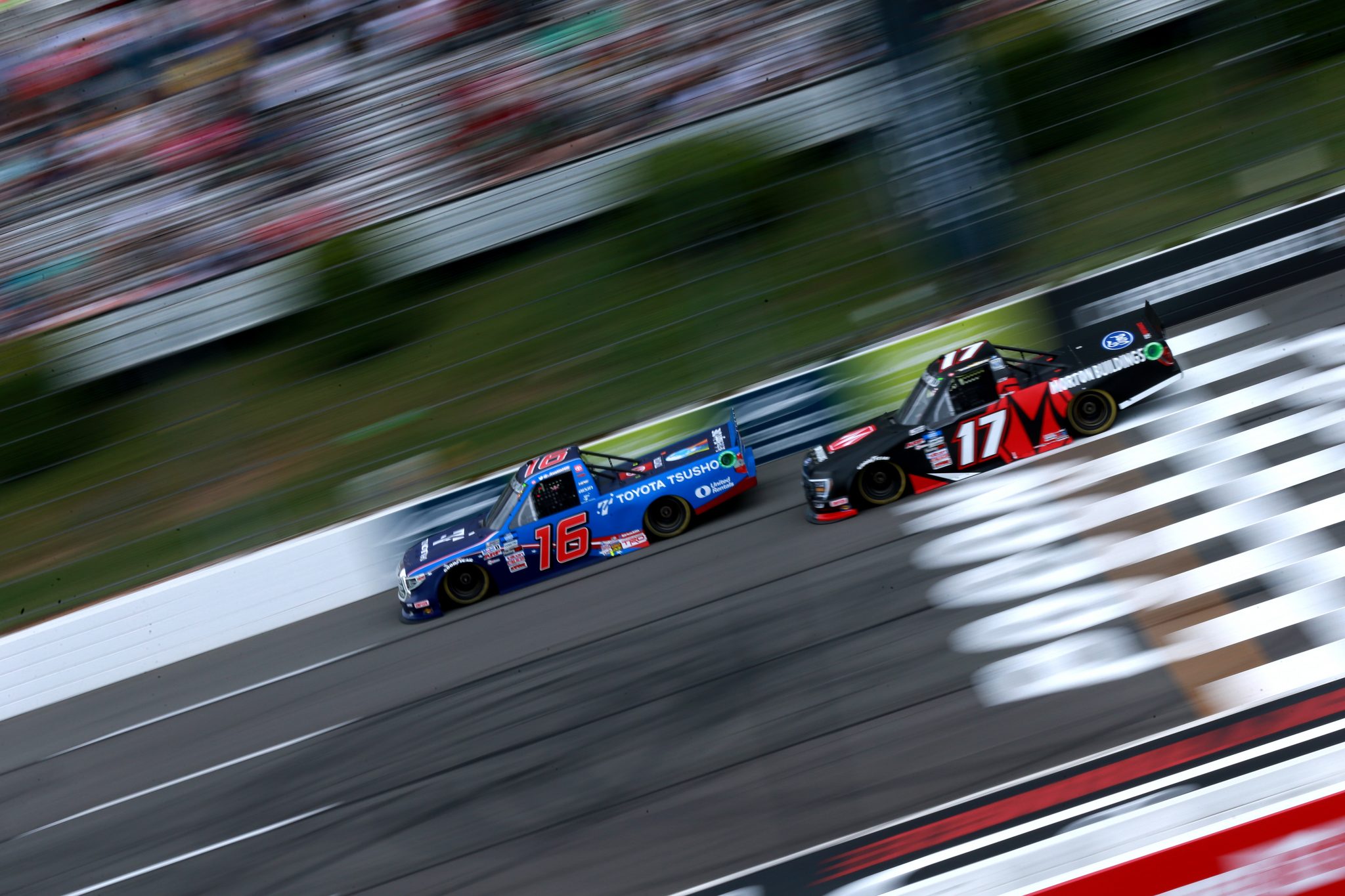 LONG POND, PENNSYLVANIA - JUNE 26: Austin Hill, driver of the #16 Toyota Tsusho Toyota, and Ryan Preece, driver of the #17 Morton Buildings Ford, race during the NASCAR Camping World Truck Series CRC Brakleen 150 at Pocono Raceway on June 26, 2021 in Long Pond, Pennsylvania. (Photo by Sean Gardner/Getty Images) | Getty Images
