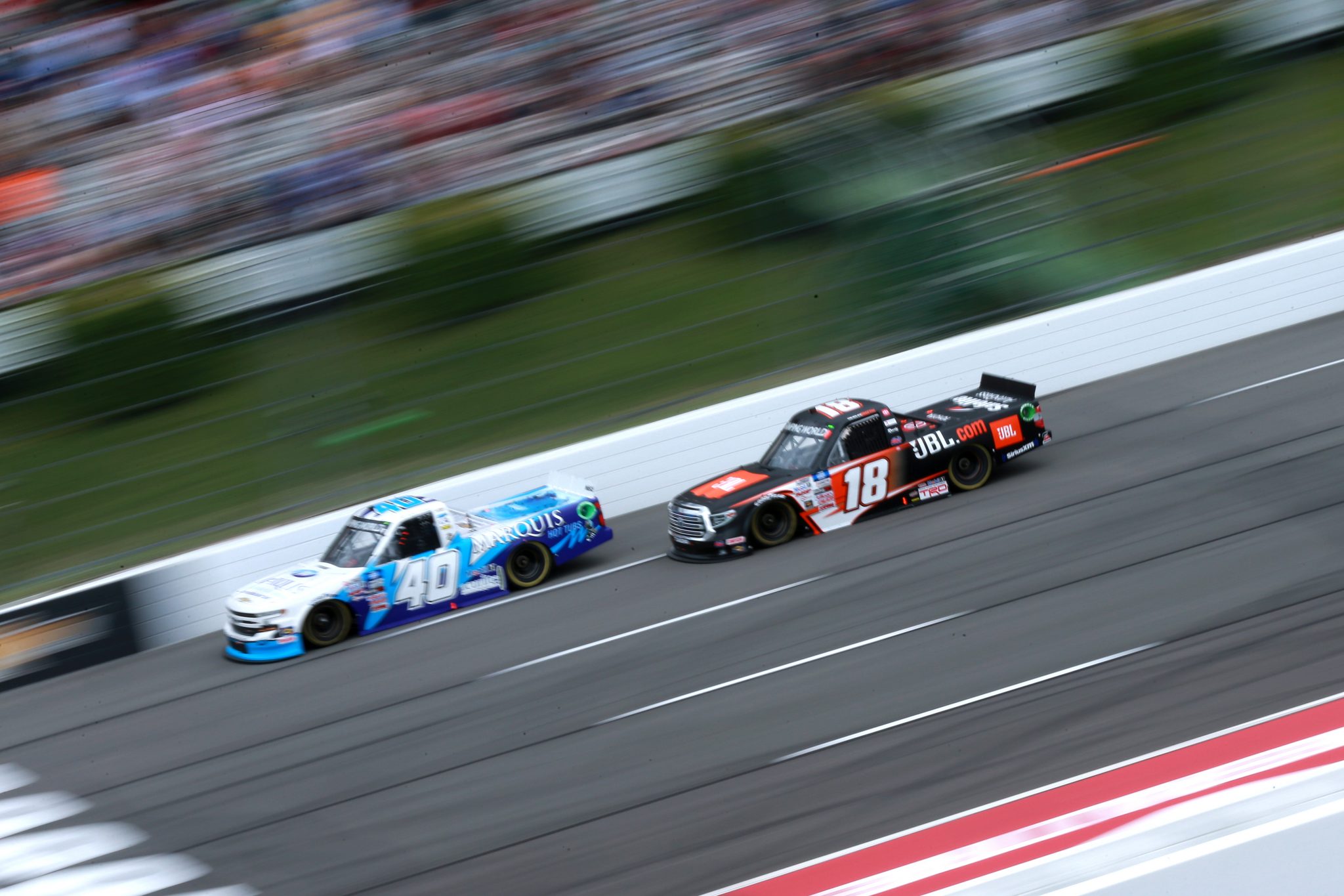LONG POND, PENNSYLVANIA - JUNE 26: Ryan Truex, driver of the #40 Marquis Spas Chevrolet, and Chandler Smith, driver of the #18 JBL Toyota, race during the NASCAR Camping World Truck Series CRC Brakleen 150 at Pocono Raceway on June 26, 2021 in Long Pond, Pennsylvania. (Photo by Sean Gardner/Getty Images) | Getty Images