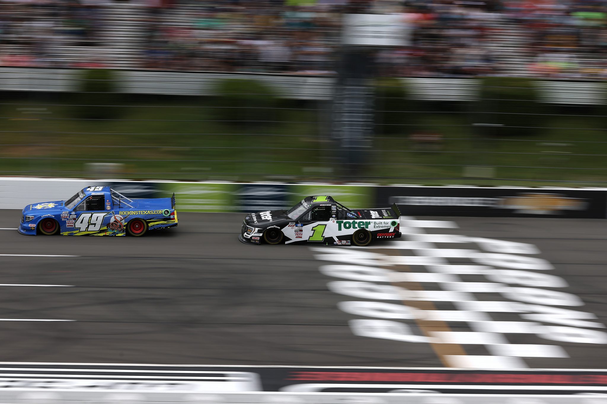 LONG POND, PENNSYLVANIA - JUNE 26: Ray Ciccarelli, driver of the #49 Sam's Dock Toyota, and Hailie Deegan, driver of the #1 Toter Ford, race during the NASCAR Camping World Truck Series CRC Brakleen 150 at Pocono Raceway on June 26, 2021 in Long Pond, Pennsylvania. (Photo by James Gilbert/Getty Images) | Getty Images