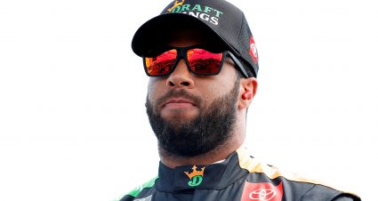 LONG POND, PENNSYLVANIA - JUNE 27: Bubba Wallace, driver of the #23 DraftKings Toyota, waits on the grid prior to the NASCAR Cup Series Explore the Pocono Mountains 350 at Pocono Raceway on June 27, 2021 in Long Pond, Pennsylvania. (Photo by Tim Nwachukwu/23XI Racing via Getty Images)